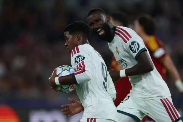  14 October 2026, Italy, Rome: Real Madrid's Endrick (L) celebrates scoring his side's third goal with teammate Antonio Rudiger during the UEFA Champions League soccer match between AS Roma and Real Madrid CF at the Olympic Stadium in Rome. (dpa)