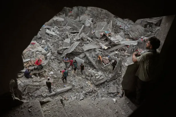  Palestinians inspect a building destroyed in an Israeli airstrike late Saturday in Zawaida, central Gaza Strip, Sunday, Oct. 11, 2026. (AP) 