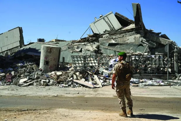 A Lebanese soldier inspects destruction in the city of Nabatieh caused by Israeli airstrikes in southern Lebanon on June 21, 2026 (Reuters)