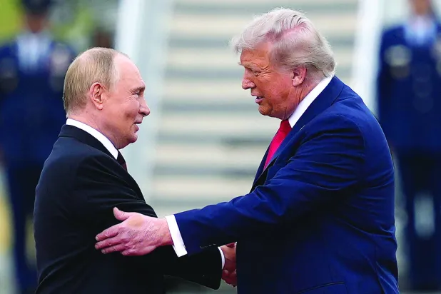 FILE - US President Donald Trump greets Russian President Vladimir Putin, Aug. 15, 2025, at Joint Base Elmendorf-Richardson, Alaska. (AP Photo/Julia Demaree Nikhinson, File)