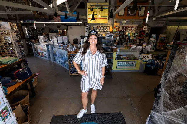 Dana Wharf Sport Fishing and Whale Watching co-owner Donna Kalez poses in front of her family's 55-year-old business on the waters of Dana Point, California, US, October 9, 2026. REUTERS/Mike Blake