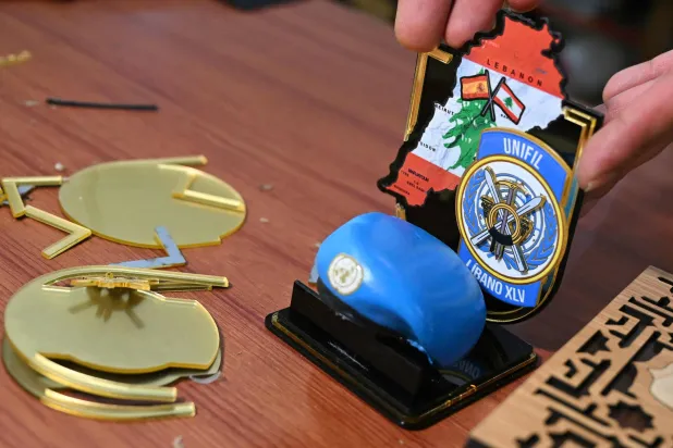 A worker arranges souvenirs made for personnel of the United Nations Interim Force in Lebanon (UNIFIL) at a factory showroom in Lebanon's southern border village of Ibl al-Saqi on October 13, 2026. (AFP)