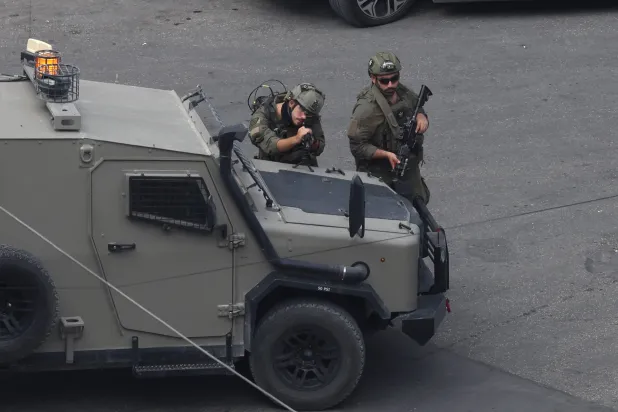 Israeli soldiers take positions during an army raid in the Rafidia area of Nablus, West Bank, 19 October 2026. (EPA)