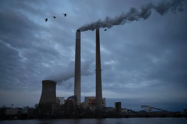 FILE - The coal-fired Mountaineer Power Plant, near New Haven, W.Va., operates across the Ohio River from the Lock 24 RV Park and Campground in Racine, Ohio, March 13, 2026. (AP Photo/Carolyn Kaster, File)