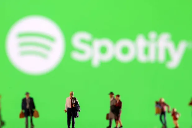 FILE PHOTO: Small figurines are seen in front of displayed Spotify logo in this illustration taken February 11, 2022. REUTERS/Dado Ruvic/Ilustration/File Photo