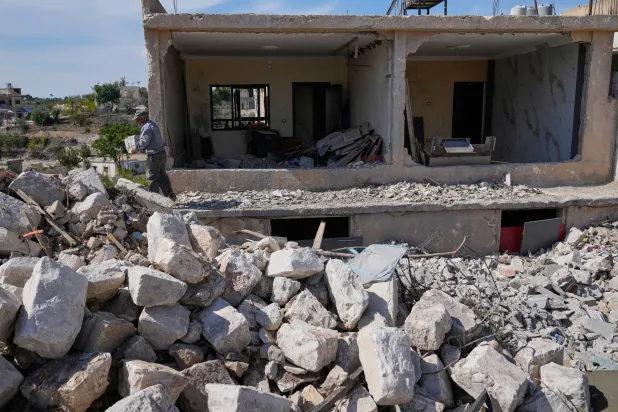 A man removes debris from his destroyed house, in Zawtar al-Gharbiyeh village, southern Lebanon, Tuesday, Oct. 20, 2026. (AP)