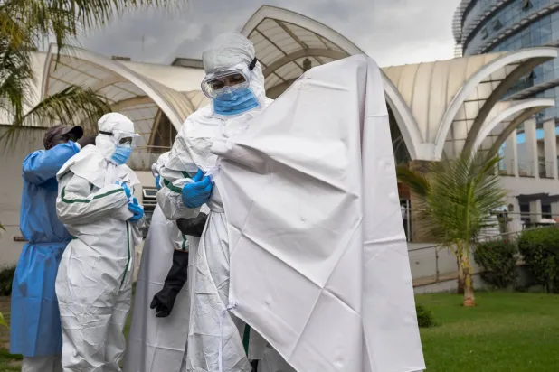 Kenya Red Cross personnel doff their Personal Protective Equipment (PPE) during a simulation of the evacuation of remains of an Ebola victim in the Kenyan capital Nairobi on October 22, 2026. (AFP)