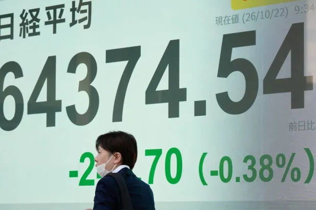  A person walks in front of an electronic stock board showing Japan's Nikkei index at a securities firm Thursday, Oct. 22, 2026, in Tokyo. (AP) 