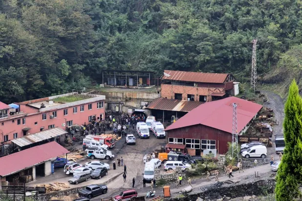 This handout photograph taken and released on October 23,2026 by Turkish news agency DHA (Demiroren News Agency) shows ambulances and fire fighters vehicles in front of a coal mine following a mining accident in Zonguldak. (Handout / DHA (Demiroren News Agency) / AFP) 
