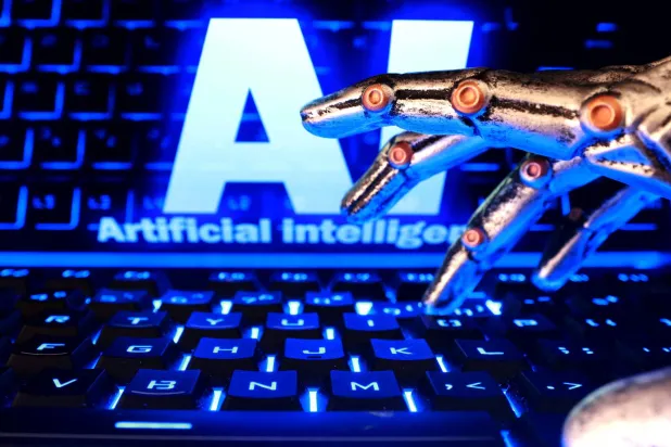 FILE PHOTO: The words "AI Artificial Intelligence", a keyboard, and a robotics hand in this illustration taken October 19, 2026. REUTERS/Dado Ruvic/Illustration/File Photo