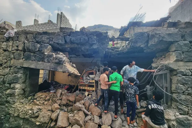 Residents walk amid debris from their homes after a missile strike in Seina, Taiz, Yemen, Tuesday, Oct. 20, 2026. (AP)