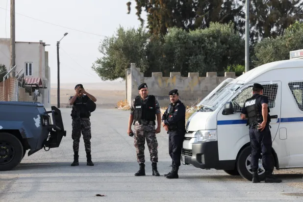 Security personnel stand outside Saint George’s Greek Orthodox Church, where gunmen opened fire during a funeral the previous day, in the village of Hamoud, Karak, Jordan, October 24, 2026. REUTERS/Alaa Al Sukhni