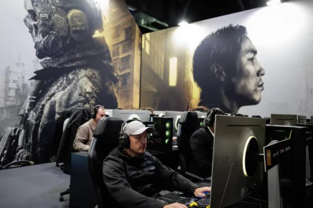 Visitors play 'Call Of Duty Modern Warfare 4' at a Paris preview last week. The game envisions a North Korean invasion of its southern neighbor. Simon WOHLFAHRT / AFP
