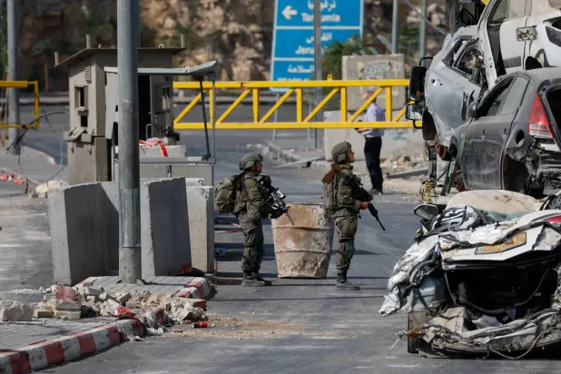 Israeli soldiers stand guard at the site of a shooting on Friday in Hebron, in the Israeli-occupied West Bank, October 24, 2026. (Reuters)