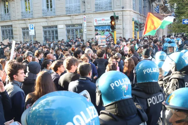 Protesters confront anti riot police during a demonstration at Lanza in Milan, Italy, 24 October 2026. (EPA)