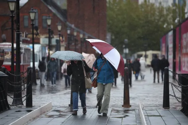 People walk through heavy rain in Liverpool, Britain, 24 October 2026. (EPA)