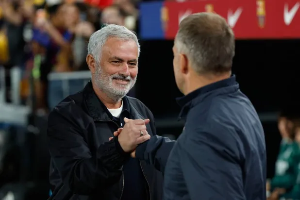  Real Madrid's head coach Jose Mourinho, left, shakes hands with Barcelona's head coach Hansi Flick during a Spanish LaLiga match between FC Barcelona and Real Madrid in Barcelona, Spain, Sunday, Oct. 25, 2026. (AP) 