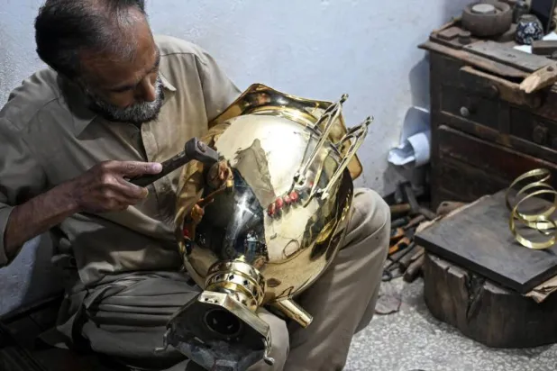 Restorer Shakeel Ahmed works on an antique at his workshop in Rawalpindi. Farooq NAEEM / AFP
