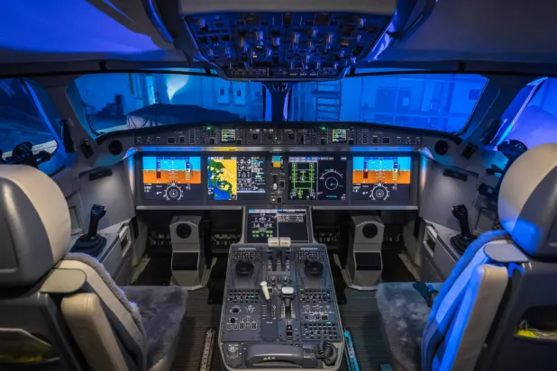 An illustration showing the layout of a modern glass cockpit, with advanced digital displays and the center pedestal located between the captain's and first officer's seats. The transponder used by pilots to enter the three-digit emergency codes 7700, 7600 and 7500 is located in this area. The codes are then displayed on air traffic controllers' radar screens. (Wikipedia)
