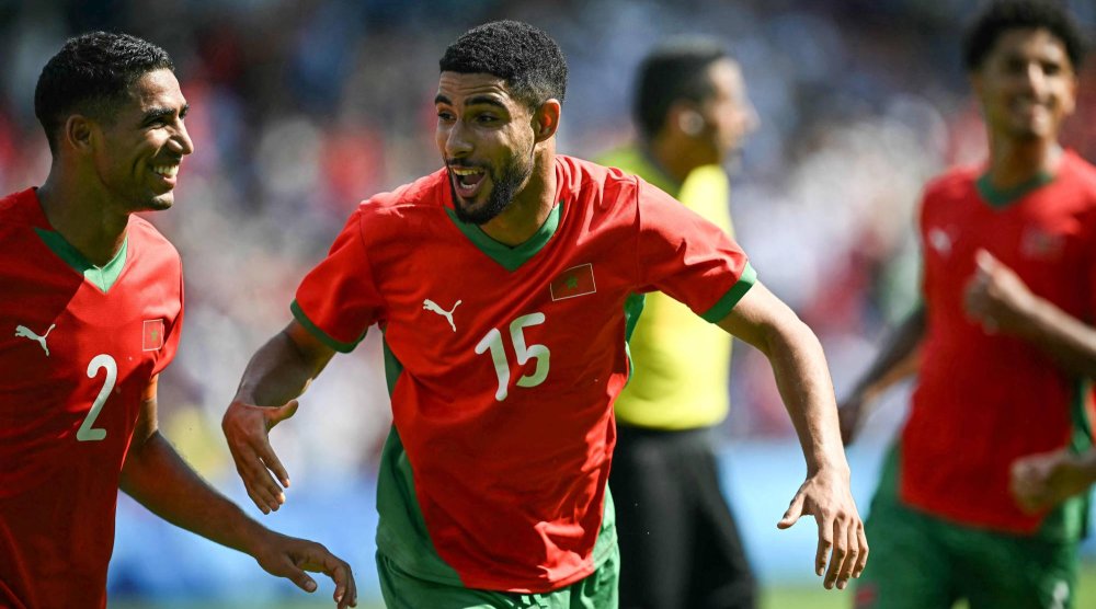 Morocco's forward #15 Mehdi Maouhoub (R) celebrates with Morocco's defender #02 Achraf Hakimi (L) after scoring a penalty kick for his team's fourth goal during the men's quarter-final football match between Morocco and the USA at the Paris 2024 Olympic Games at the Parc des Princes in Paris on August 2, 2024. (Photo by Paul ELLIS / AFP)