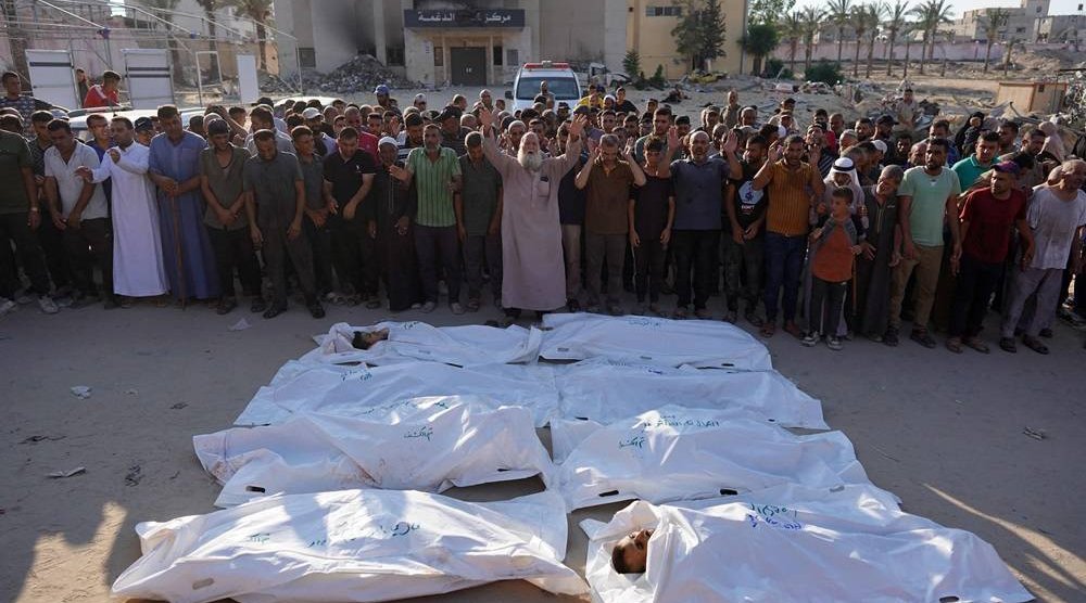  Palestinians recite a prayer over the bodies of people killed in Israeli bombardment, at the Nasser hospital in Khan Younis in the southern Gaza Strip on August 14, 2024, amid the ongoing conflict between Israel and the Hamas group. (AFP) 