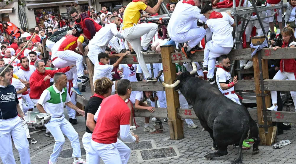 'Mozos' or runners take part in the second Running of the Bulls during the Sanfermines festival in Pamplona, Spain, 08 July 2025. The San Fermin festival runs until 14 July 2025. EPA/Daniel Fernandez