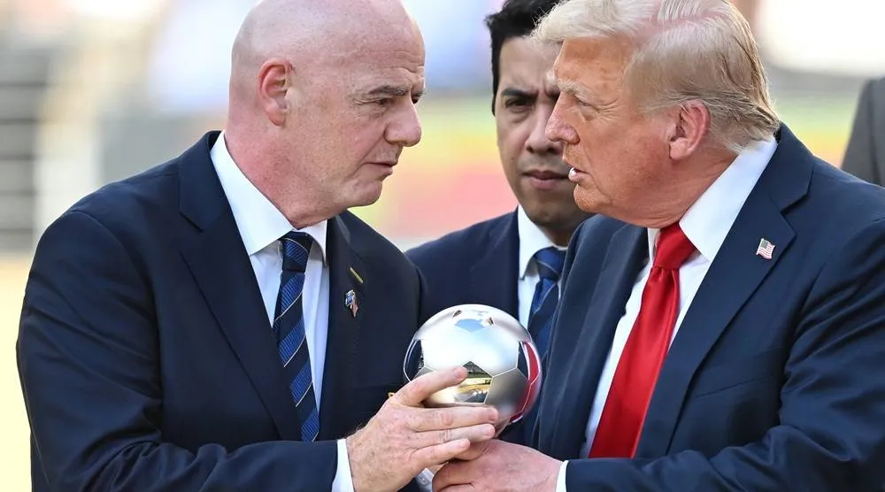  13 July 2025, US, East Rutherford: US President Donald Trump (R) and FIFA President Gianni Infantino hold the trophy during the award ceremony following the FIFA Club World Cup final between Chelsea FC and Paris Saint-Germain at MetLife Stadium. (dpa)