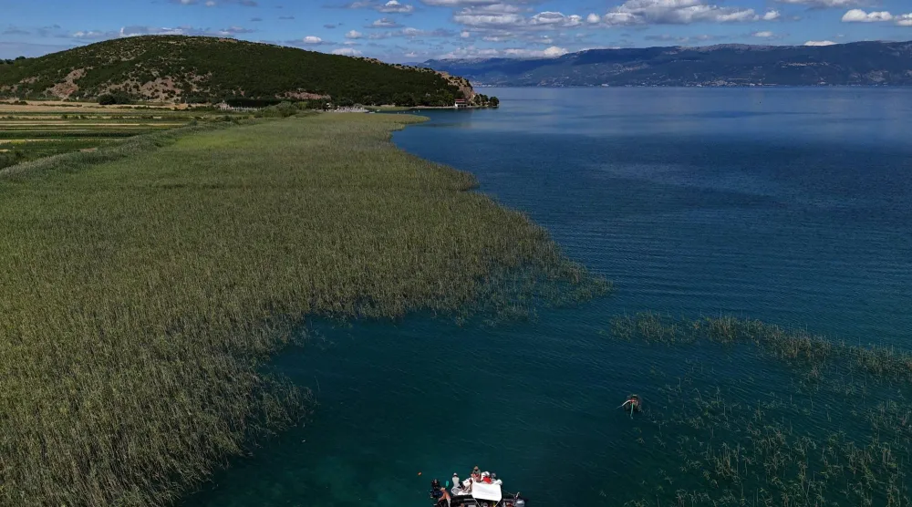 A drone view shows archaeologists diving in the lake of Ohrid to uncover objects, in the village of Lin, Albania, July 10, 2025. REUTERS/Fatos Bytyci