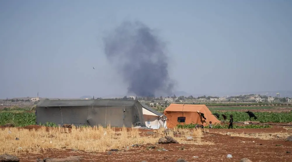 Smoke rises from fires in areas controlled by Druze factions in the Sweida countryside, Syria, 17 July 2025. (EPA)
