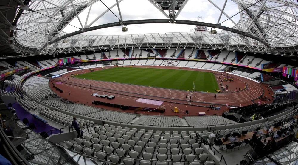 FILE -Workers continue setup preparations ahead of the start of the World Athletics Championships at the London Stadium, in the Queen Elizabeth Olympic Park in London, Aug. 1, 2017. (AP Photo/Matt Dunham, File)