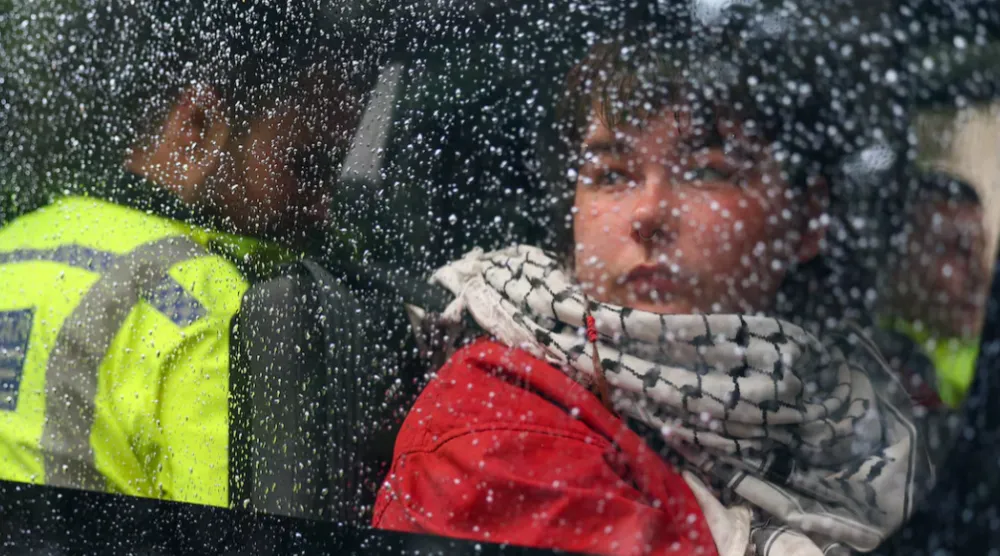 A detained demonstrator sits inside a police van, following a protest in support of the Palestine Action group in Parliament Square in London, Britain, July 19, 2025. REUTERS/Isabel Infantes 