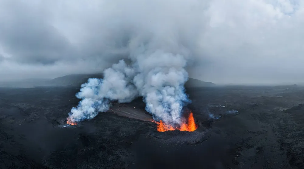 Smoke and lava rise from a volcano eruption near Reykjanes, Iceland, 19 July 2025. EPA/JAKOB VEGERFORS