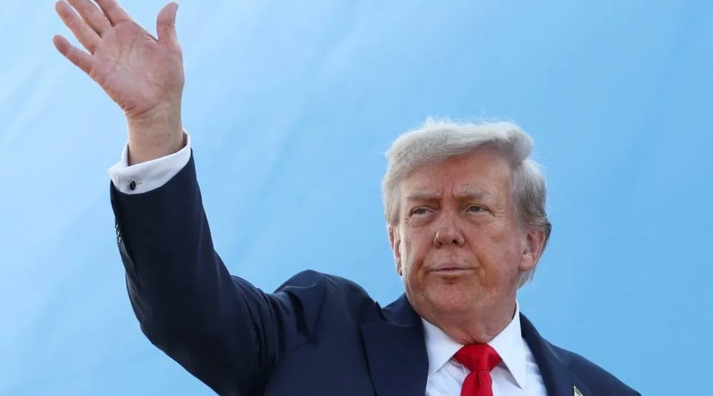 US President Donald Trump waves while boarding Air Force One, as he departs for Alaska to meet with Russian President Vladimir Putin to negotiate for an end to the war in Ukraine, from Joint Base Andrews in Maryland, US, August 15, 2025. (Reuters) 