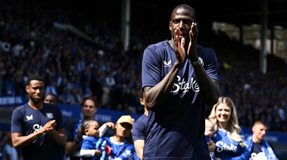 Football - Premier League - Everton v Southampton - Goodison Park, Liverpool, Britain - May 18, 2025 Everton's Abdoulaye Doucoure applauds fans as he walks on the pitch during a commemorative ceremony after his last match at Goodison Park. (Reuters)