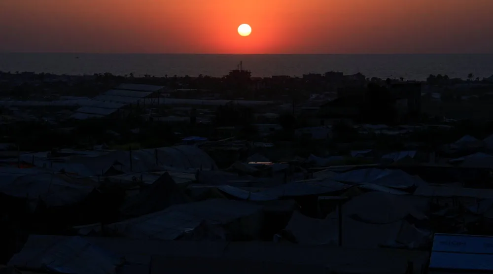 Palestinians, displaced by the Israeli military offensive, shelter in a tent camp, during sunset in Khan Younis, in the southern Gaza Strip, August 19, 2025. REUTERS/Hatem Khaled
