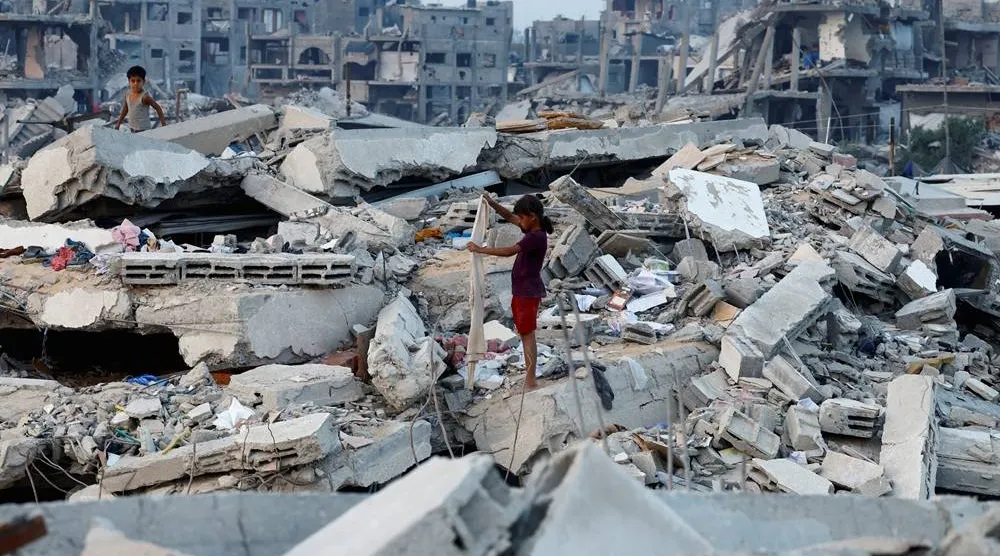  Palestinians stand on the rubble of destroyed buildings, amid a ceasefire between Israel and Hamas, in Jabalia, northern Gaza Strip, November 6, 2025. (Reuters)