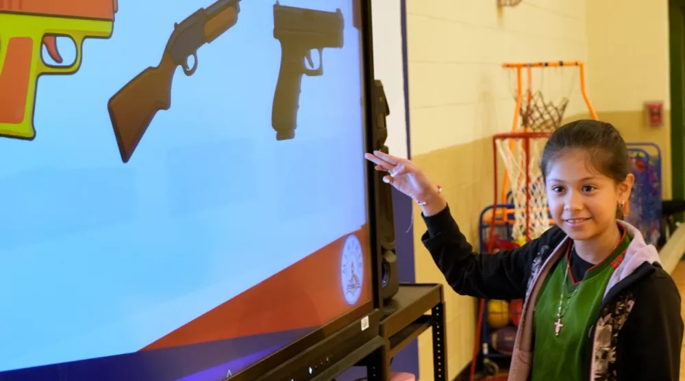 Jailyn Martinez points to a real firearm during a gun safety lesson at Berclair Elementary School, Monday, Oct. 27, 2025, in Memphis, Tenn. (AP Photo/George Walker IV)