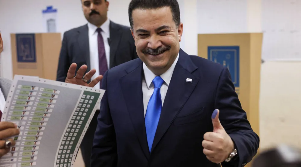 Iraqi Prime Minister Mohammed Shia al-Sudani shows his ink-stained finger after voting at a polling station in the Green Zone during the parliamentary election, in Baghdad, Iraq, November 11, 2025. (Reuters)