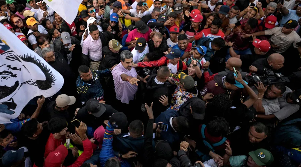 الرئيس الفنزويلي نيكولاس مادورو يلوّح بيده بين الناس خلال تظاهرة في «يوم الشباب» في كاراكاس (أ.ف.ب)