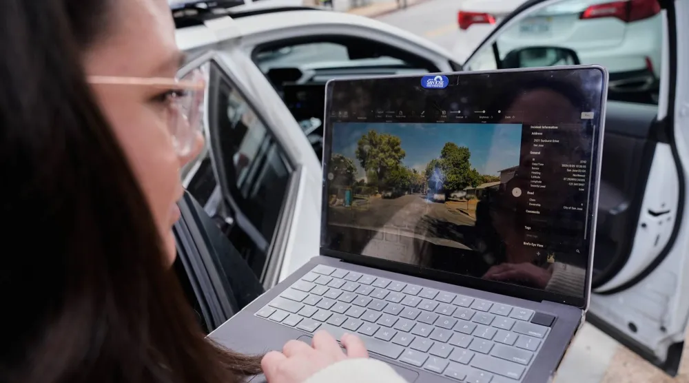 Chelsea Palacio, public information manager for the City of San Jose, showcases how a small detection camera uses AI to detect road hazards and potholes, in San Jose, Calif., Wednesday, Nov. 12, 2025. (AP Photo/Godofredo A. Vásquez)
