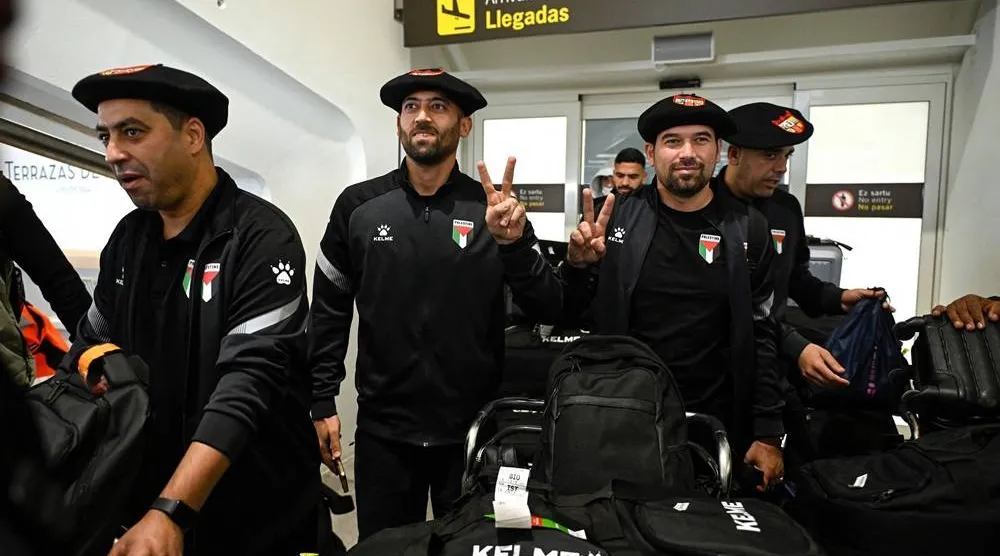 Palestinian national football team members wear the traditional Basque "txapela" (beret) as they arrive at Bilbao airport ahead of their friendly match against the Basque national team in Bilbao on November 11, 2025. (AFP)
