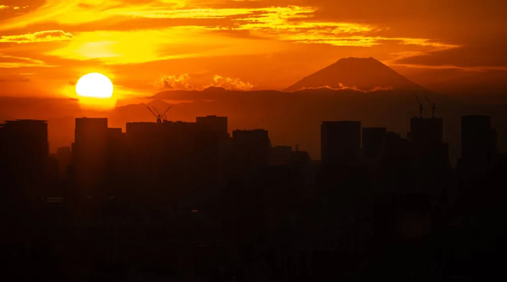 Mount Fuji and city's skyline are pictured from Tower Hall Funabori Observation Deck in Edogawa district of Tokyo on November 12, 2025. (Photo by Philip FONG / AFP)