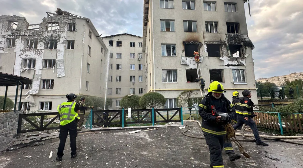 رجال الإطفاء يعملون في موقع مبنى سكني تعرض لغارة جوية روسية بطائرة دون طيار وسط هجوم روسي على أوكرانيا في خاركيف (رويترز)