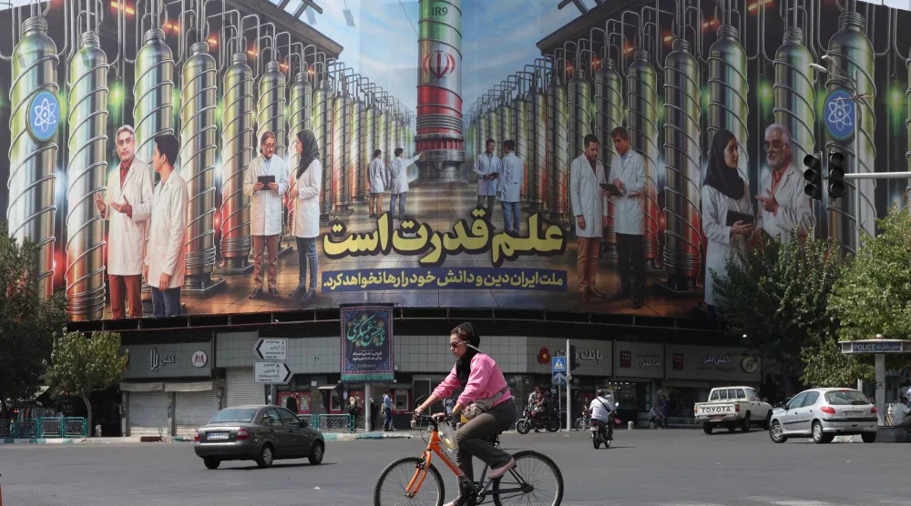  لوحة إعلانية تعرض صورة أجهزة الطرد المركزي النووية وجملة تقول «العلم هو القوة والأمة الإيرانية لن تتخلى عن دينها ومعرفتها» بطهران (إ.ب.أ)