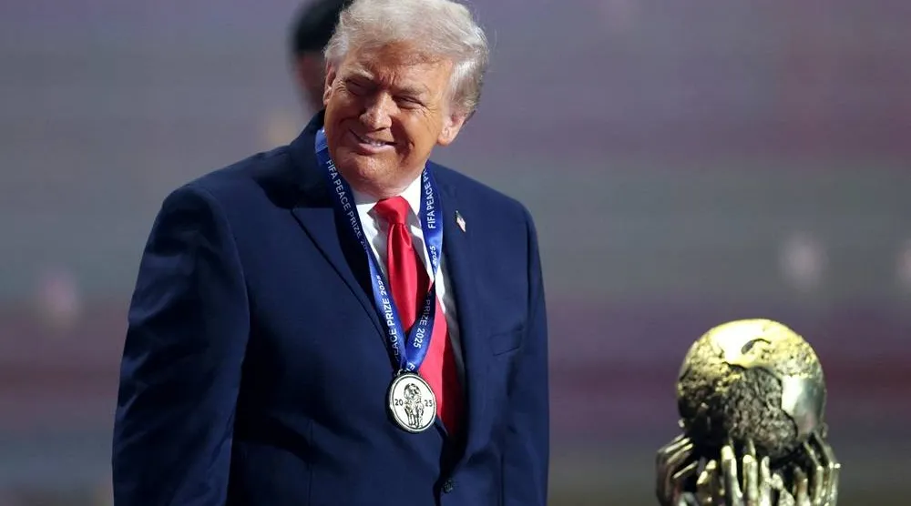 Football - FIFA World Cup 2026 - FIFA World Cup 2026 Draw - John F. Kennedy Center for the Performing Arts, Washington, DC, US - December 5, 2025 US President Donald Trump wears his medal as he is awarded the FIFA Peace Prize. (Reuters)