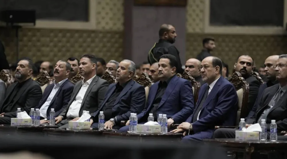 Iraqi Prime Minister Mohammed Shia al-Sudani stands beside Nouri al-Maliki during a religious event in Baghdad (Government Media)