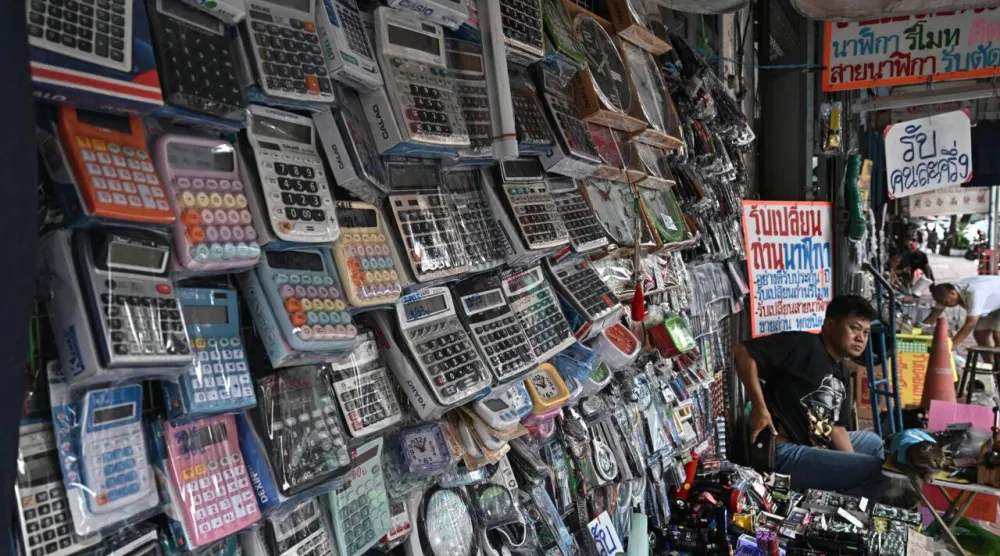 Calculators are more affordable than phones, and run on batteries and solar power. Lillian SUWANRUMPHA / AFP
