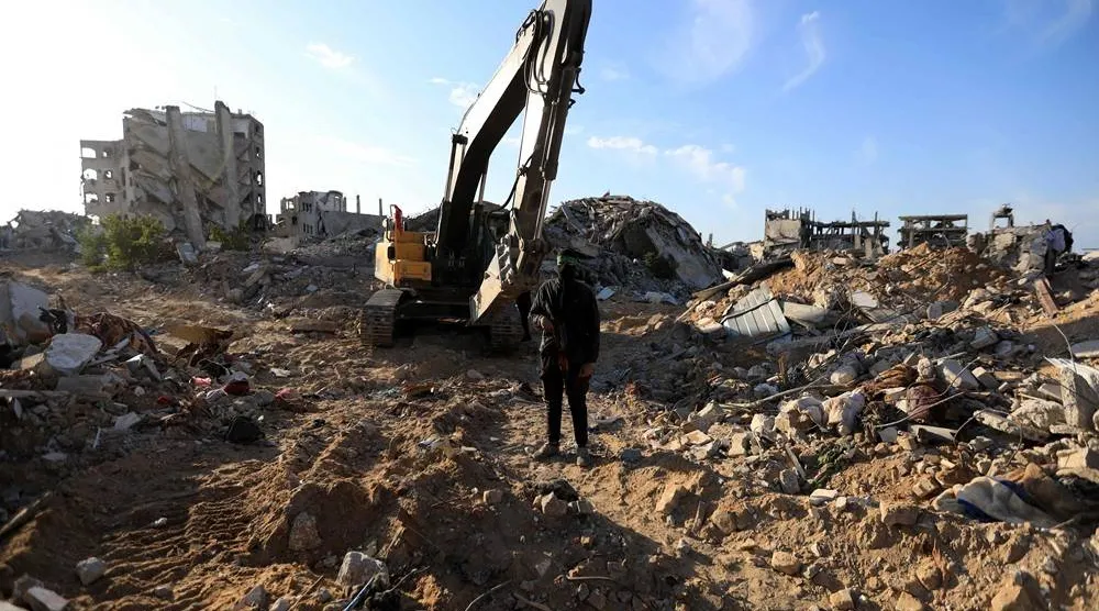 A Palestinian gunman stands guard as Hamas and Islamic Jihad fighters transport a white body bag believed to carry the remains of an Israeli hostage in the town of Beit Lahia in the northern Gaza Strip on December 3, 2025. (AFP)