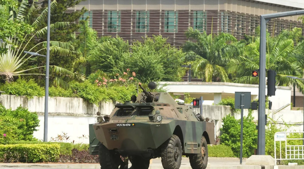 انتشار عسكري خارج مقر الإذاعة والتلفزيون في كوتونو 7 ديسمبر (رويترز)