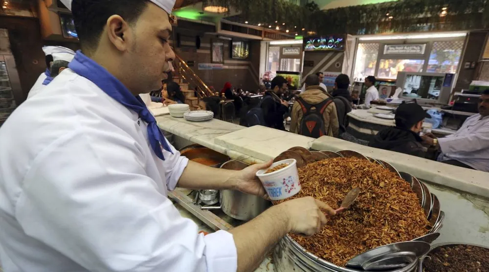 A worker prepares koshary at a shop in Cairo, January 17, 2015. (Reuters)